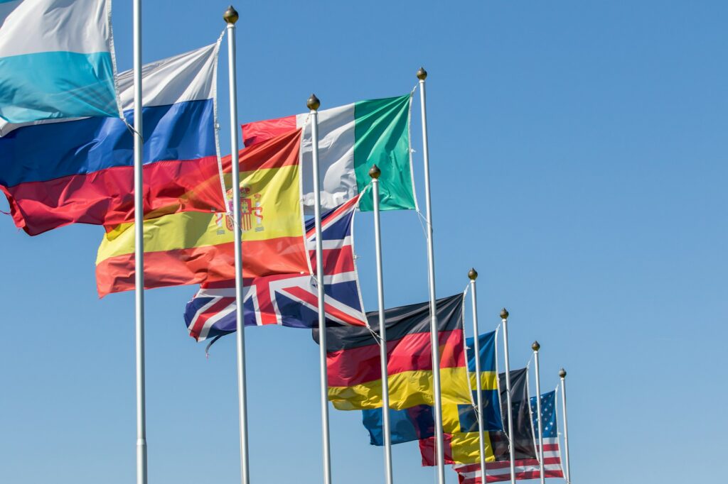 Series of different flags nations waving in the sky